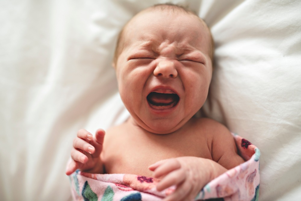 Cute,Newborn,Baby,Crying,In,Bed,At,Home