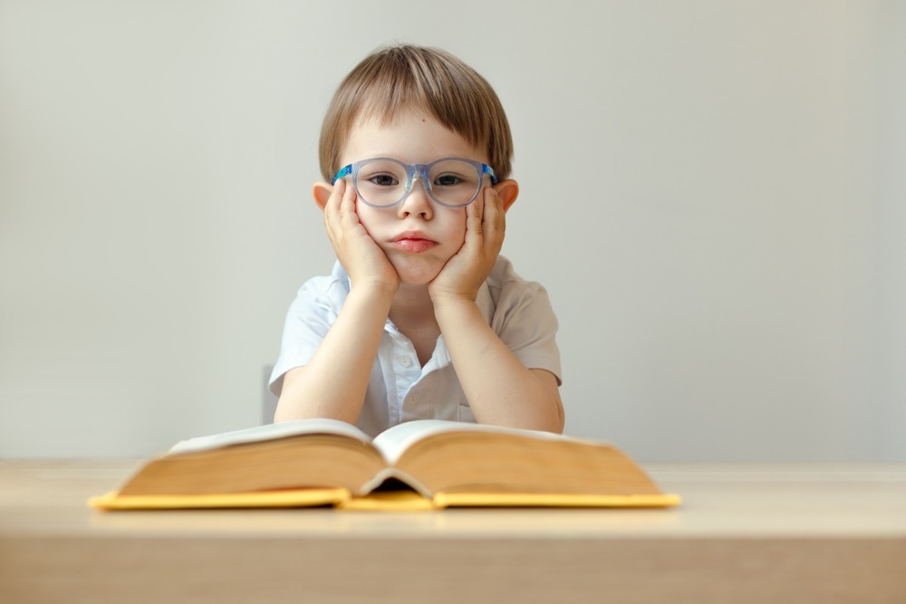 Sad,Boy,3,Year,Old,With,An,Open,Book,In