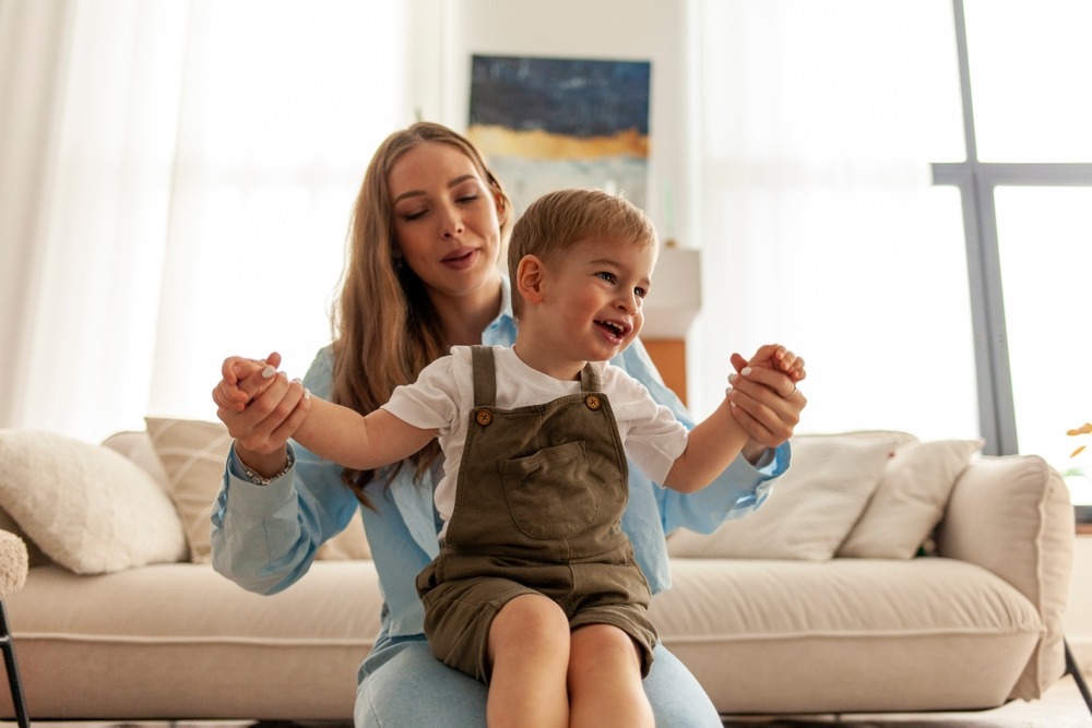 Young,Mother,Is,Holding,Her,Little,Son,In,Her,Arms